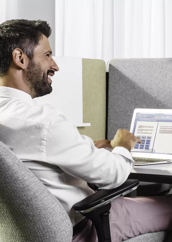 A man using a laptop in an office